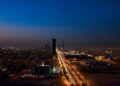 Dramatic aerial twilight view of Riyadh city skyline with lit streets