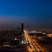 Dramatic aerial twilight view of Riyadh city skyline with lit streets