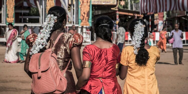 Women in vibrant traditional attire at a festive gathering in Jaffna, Sri Lanka